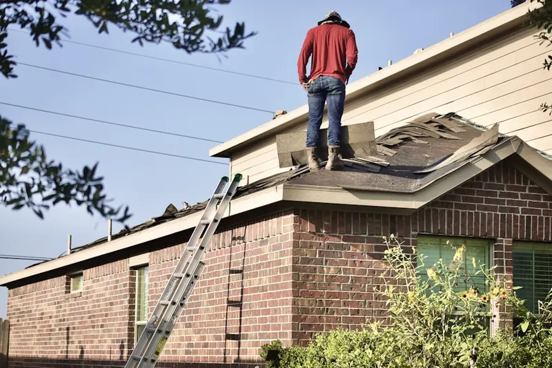 Professional roofer working on a residential roof in Avallon at Moyers